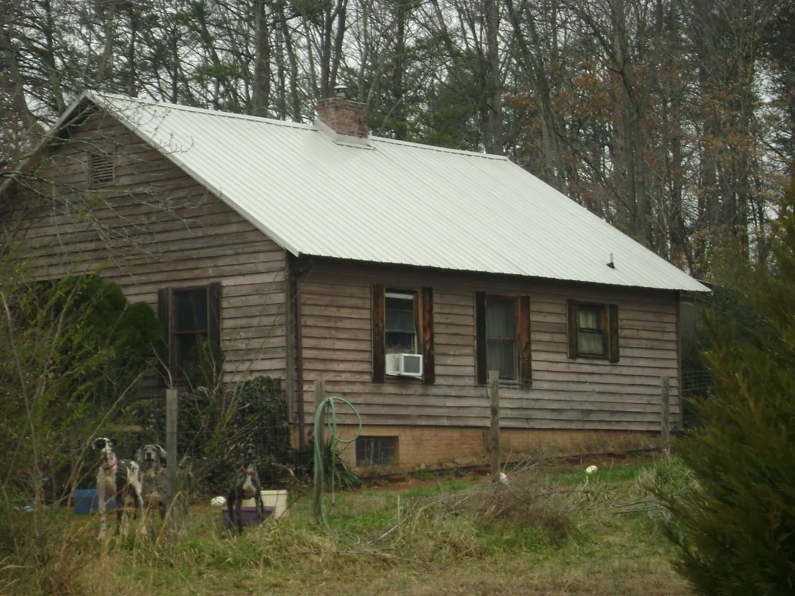 White metal roof on an old wood sided farmhouse, from a Metal Roof Installation job in Lowell
